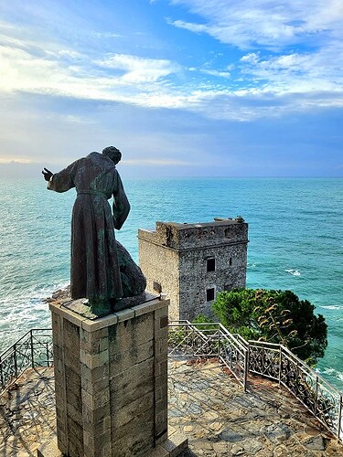 statue de saint-françois d'assis vue de dos, face à la mer